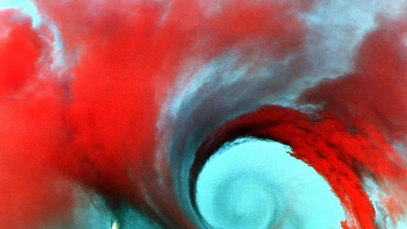 Colored smoke reveals a wingtip vortex trailing an aircraft in a NASA wake-vortex study