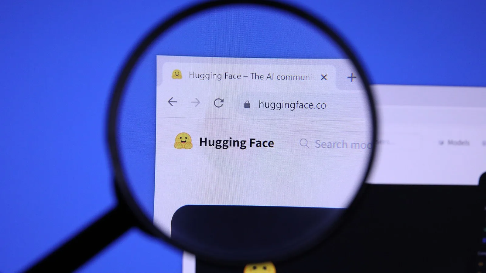 The Hugging Face logo under a magnifying glass
