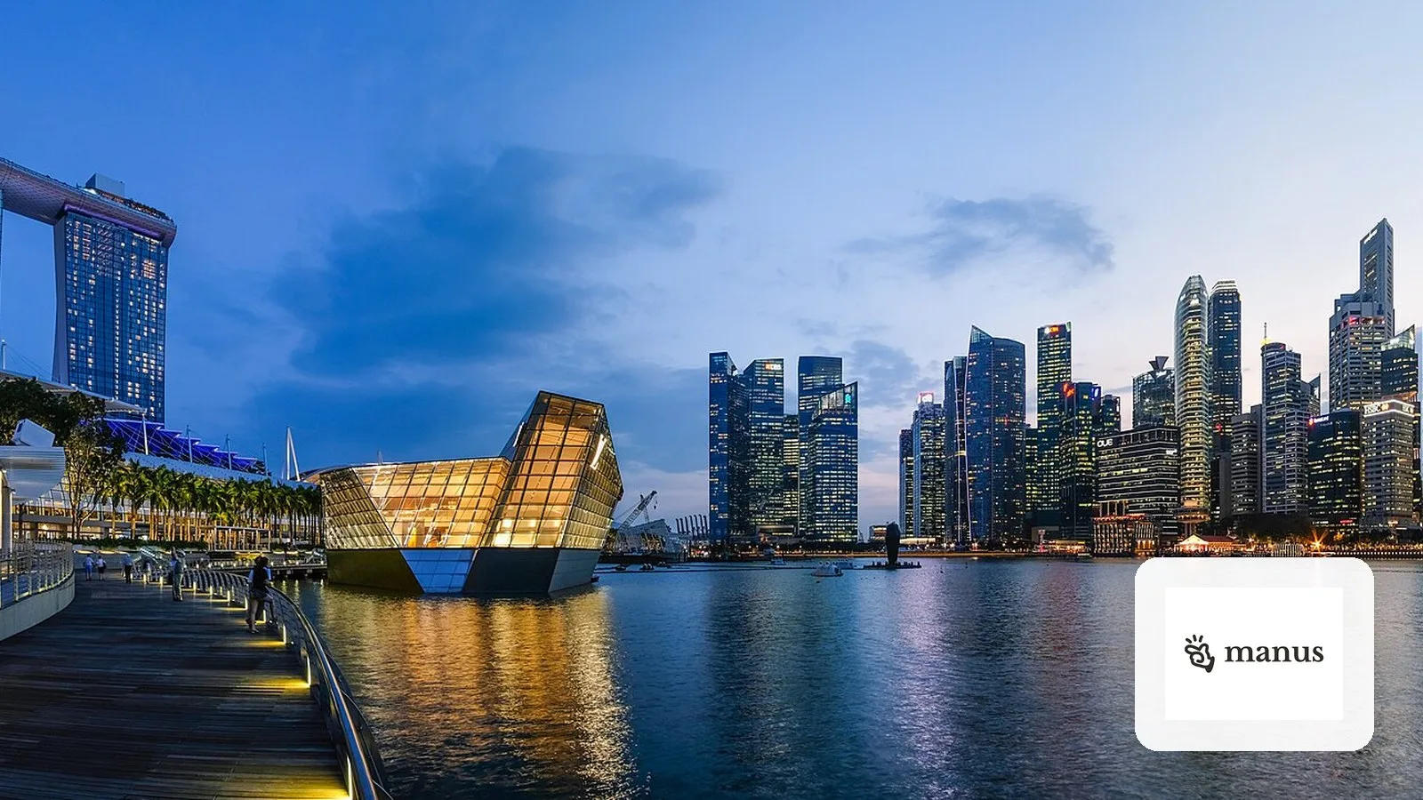 Singapore's Marina Bay skyline at dusk, with the Manus logo